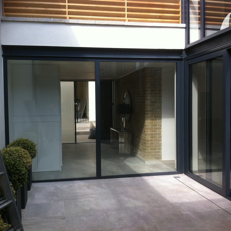 Floor-to-ceiling sliding doors opening to courtyard in Aldgate